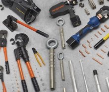Numerous Nicopress Manual, Hydraulic, and Battery Operated Tools and Compression Products Displayed on a Table