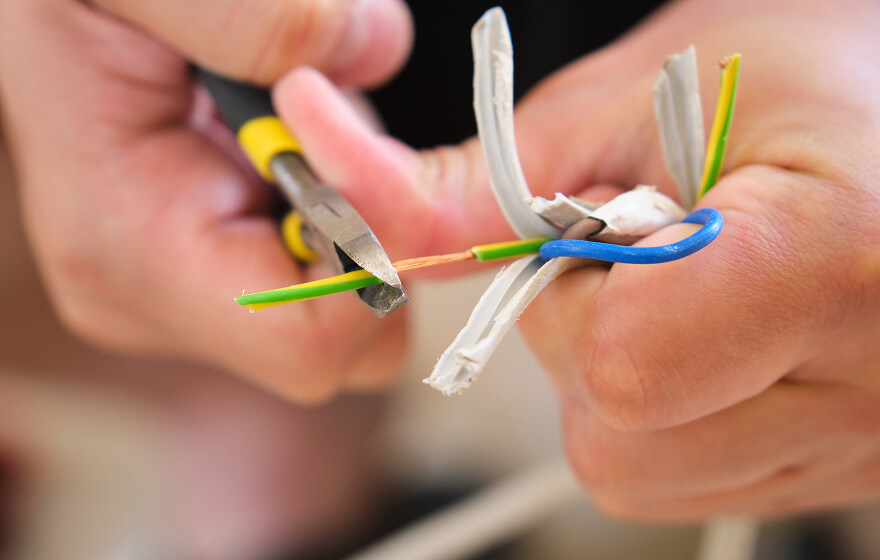 Close up of an electrician splicing wires.