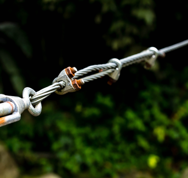Nicopress compression sleeve assembly on wire rope showing metal connector and cable termination
